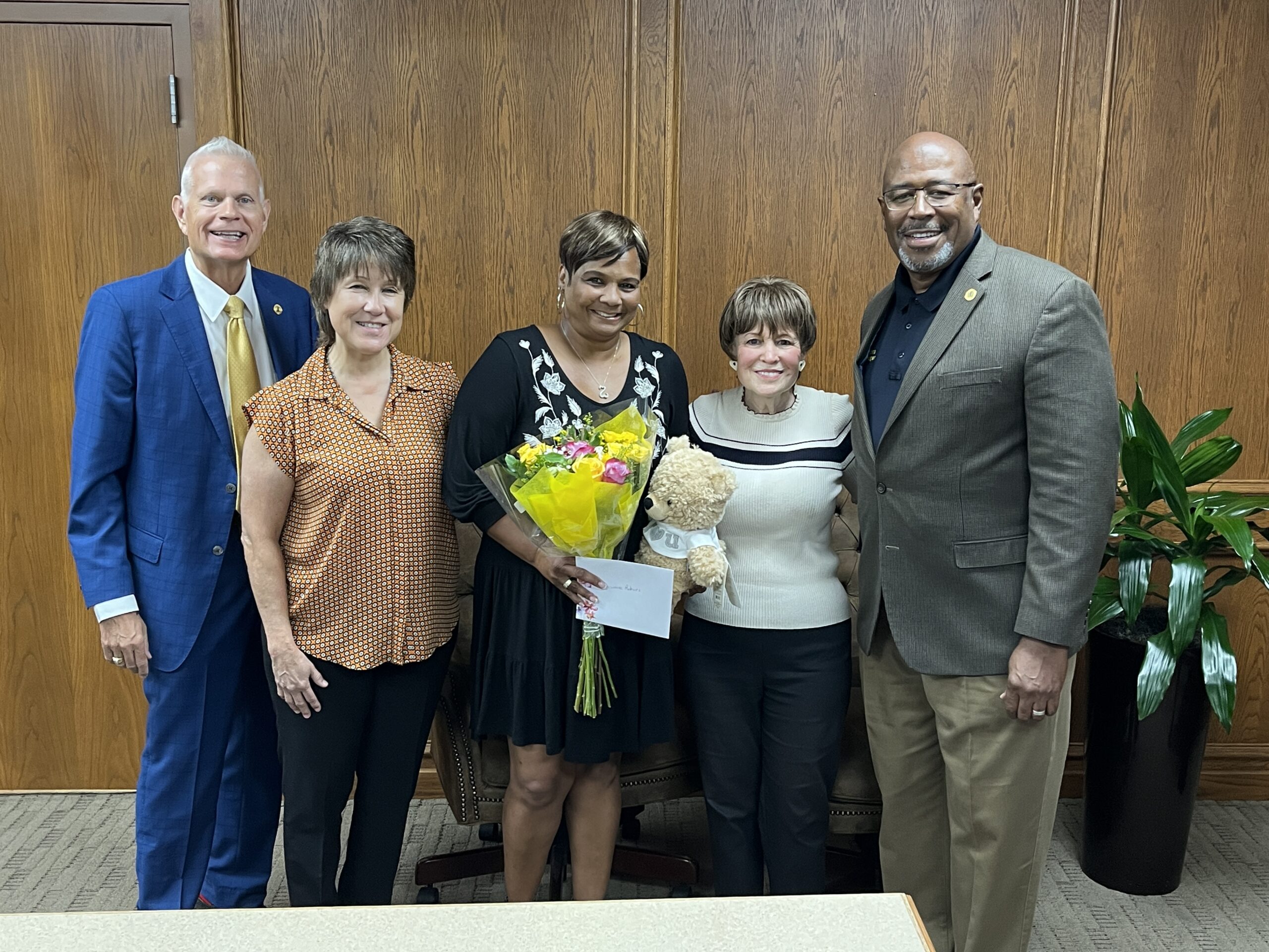 Duwane Roberts receives the Heart of the City award by Mayor Roy West, Claudia San Miguel, and City Manager Kenneth Williams.