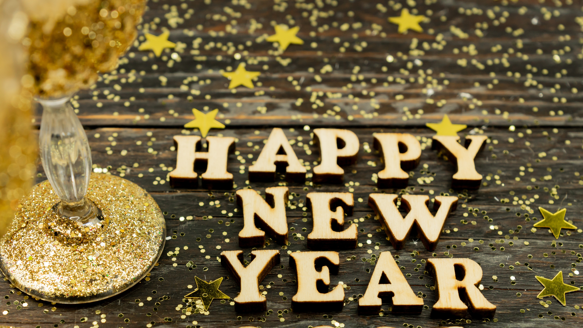 Happy New year 2021 celebration.Champagne glasses and and text happy new year In wooden text.