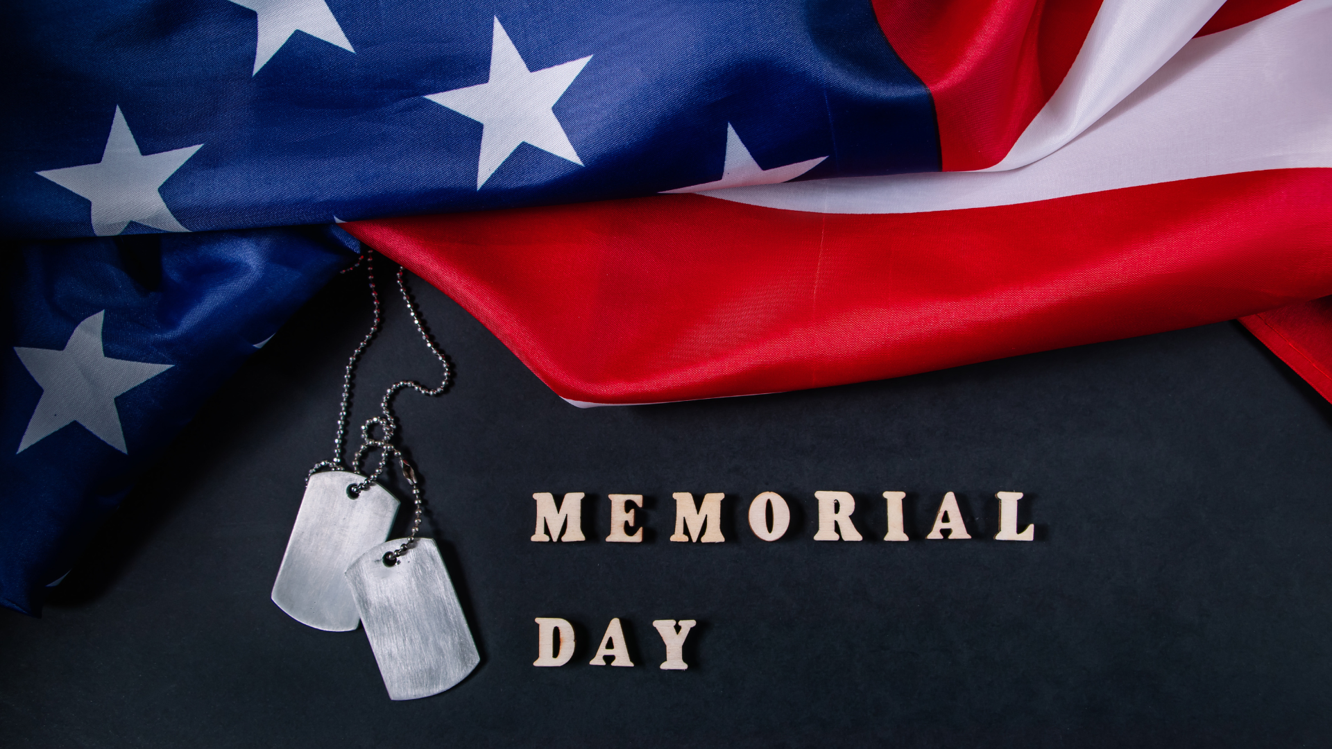 Memorial day concept. American flag and military dog tags on a black background. Remember and honor.