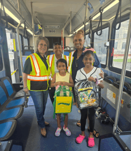 Zip Takes You School Outreach Team with Two Students.